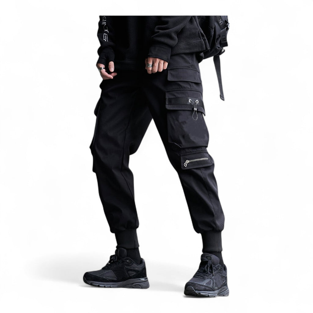 Men's gothic techwear cargo pants in black with tactical pockets, zipper detail, and ribbed jogger cuffs