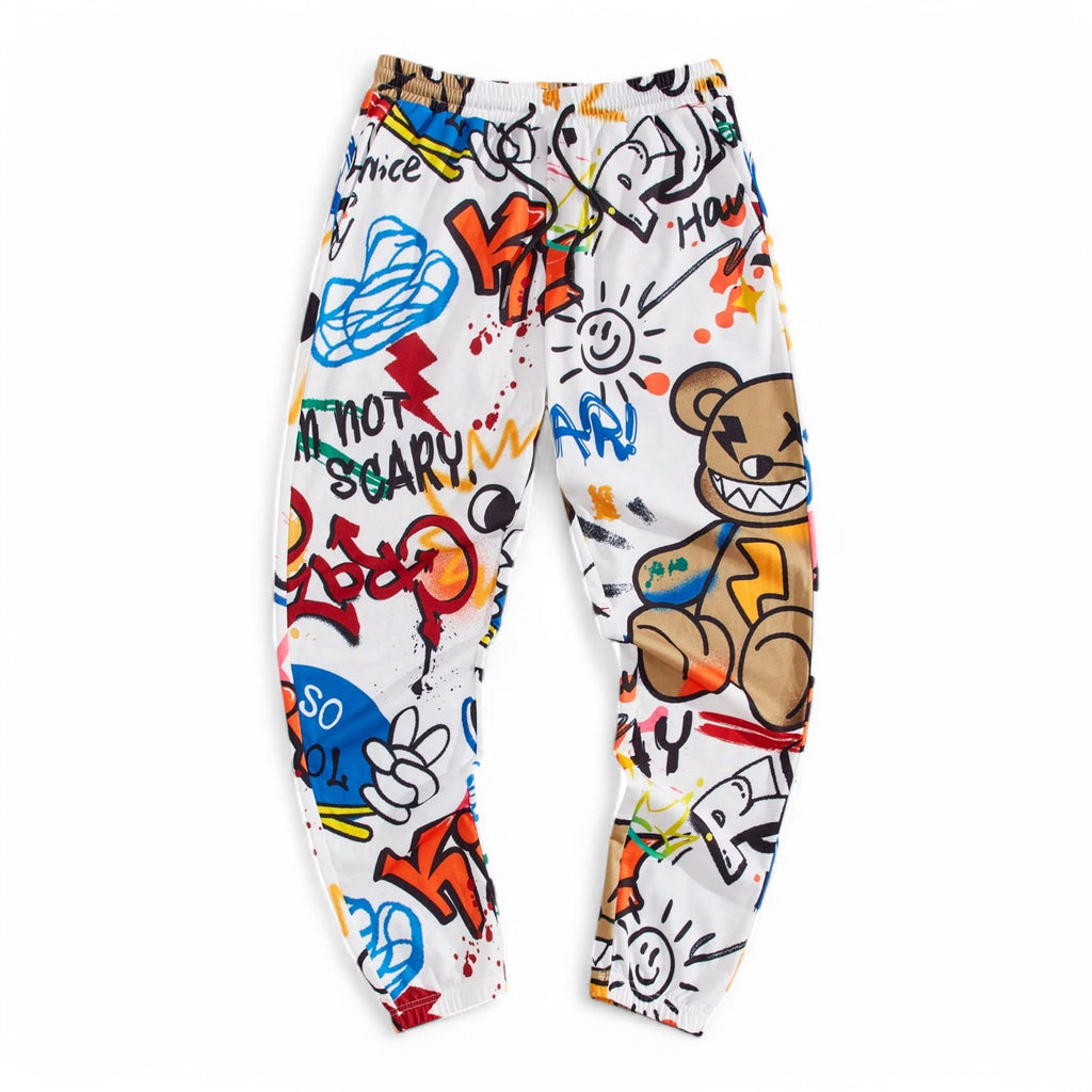 Graffiti-style multicolor jogger pants with cartoon bear and letter graphics, styled in bold Japanese streetwear fashion