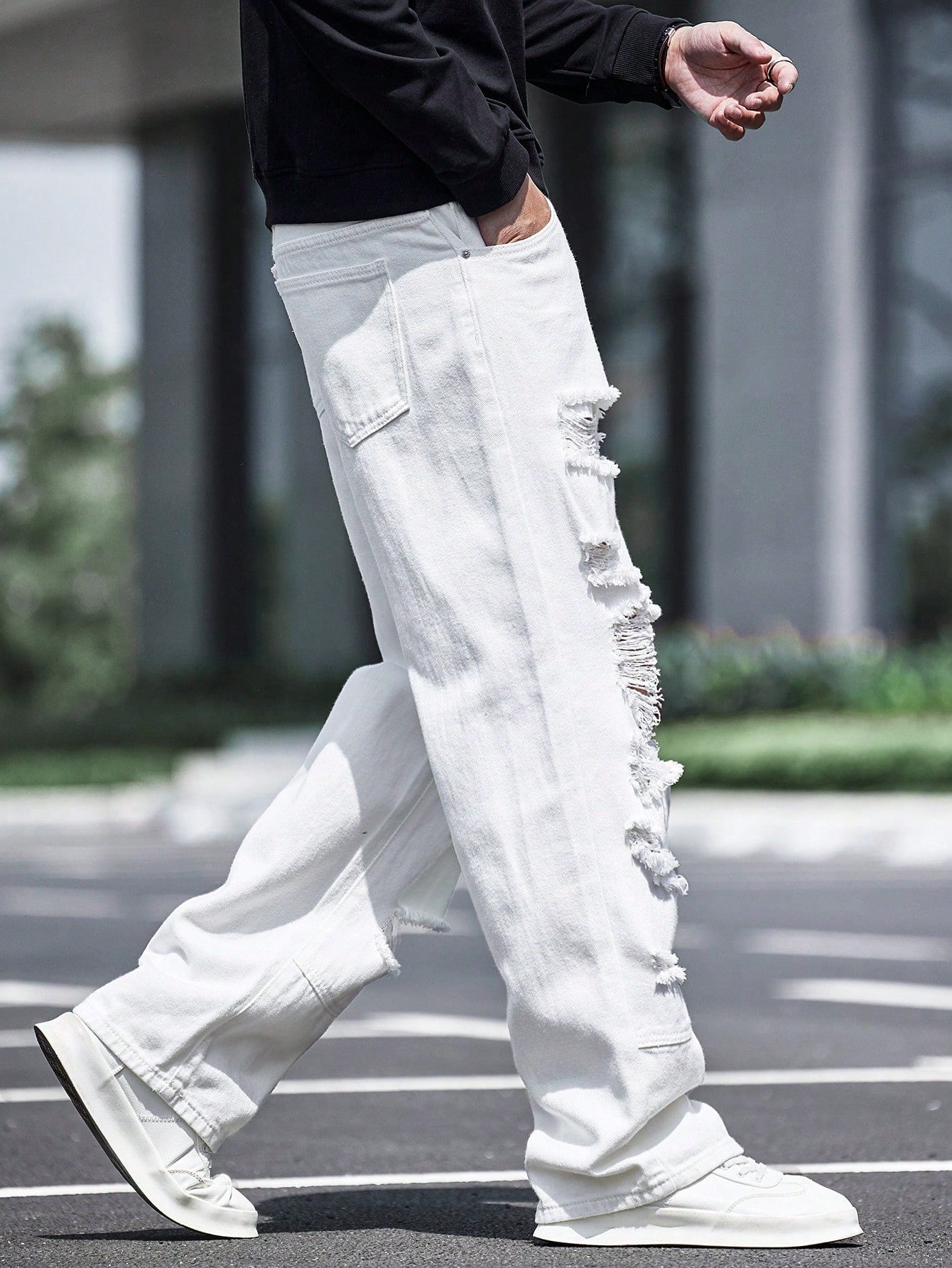 Men’s white ripped wide-leg jeans with heavy distressing and streetwear fit