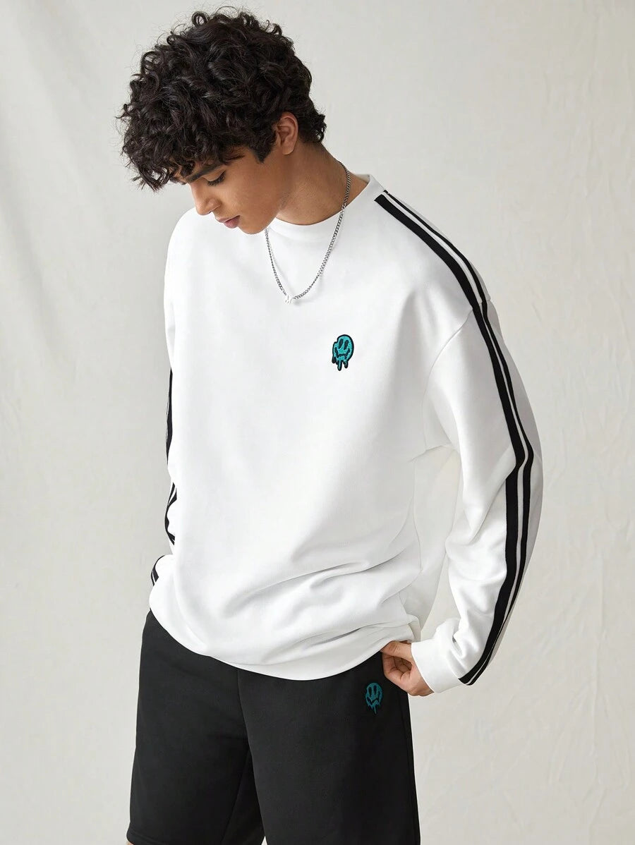 Japanese streetwear white pullover sweatshirt with black side stripes, loose fit, and embroidered chest detail