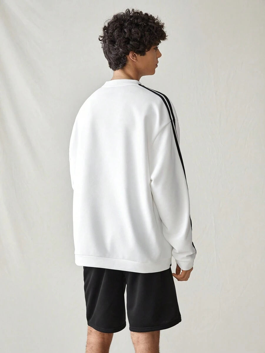 Japanese streetwear white pullover sweatshirt with black side stripes, loose fit, and embroidered chest detail