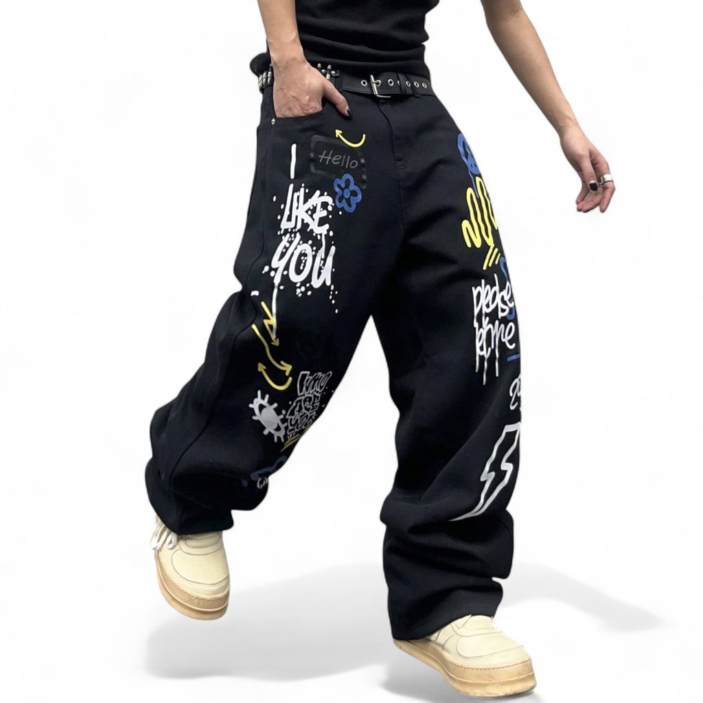 Black graffiti print wide leg jeans with colorful street art slogans and hip-hop styling
