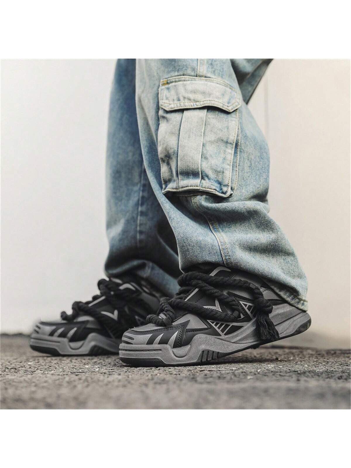 Chunky grey black sneakers with thick rope laces, futuristic streetwear platform shoes