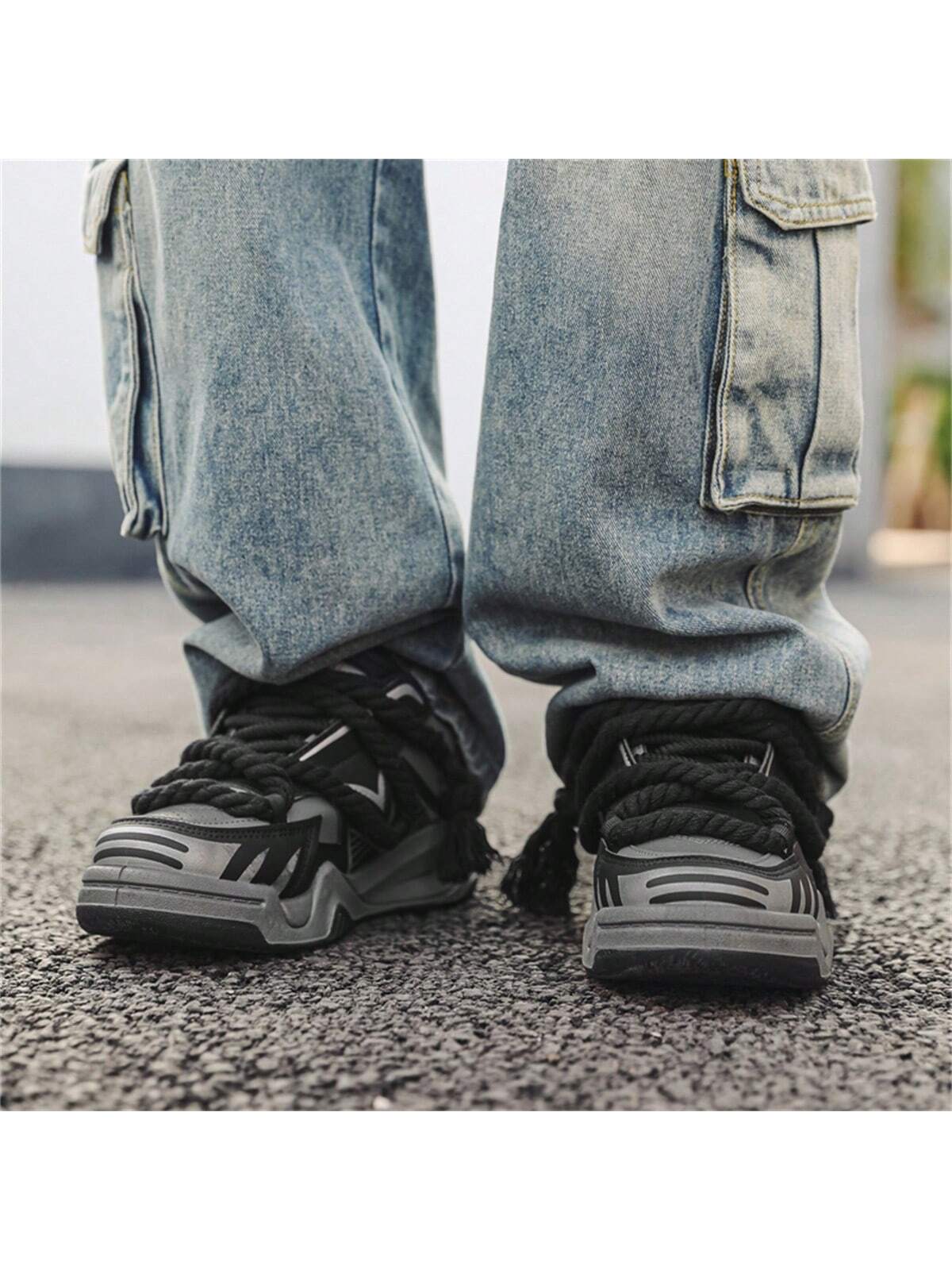Chunky grey black sneakers with thick rope laces, futuristic streetwear platform shoes
