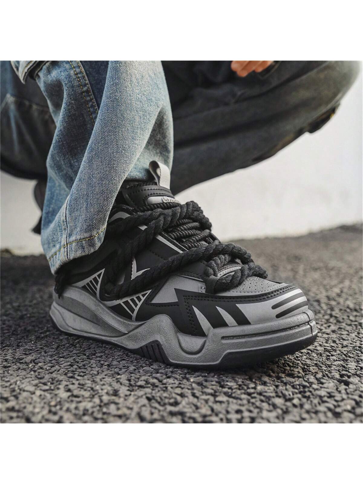 Chunky grey black sneakers with thick rope laces, futuristic streetwear platform shoes