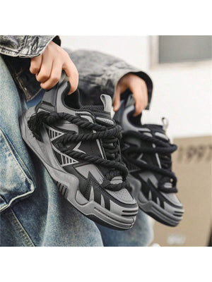 Chunky grey black sneakers with thick rope laces, futuristic streetwear platform shoes
