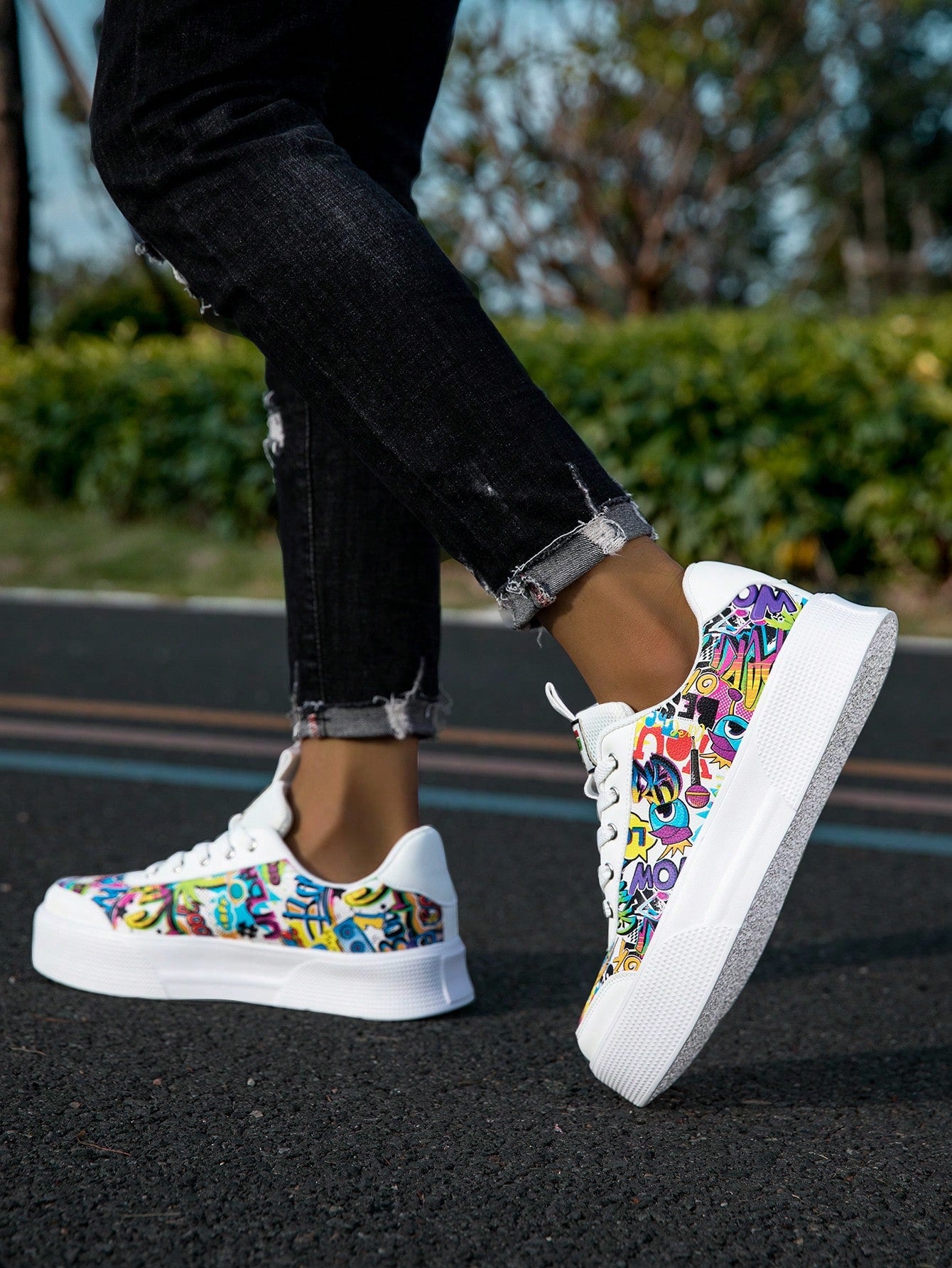 Colorful graffiti street sneakers with white base and comic-style print, lace-up low tops with EVA sole