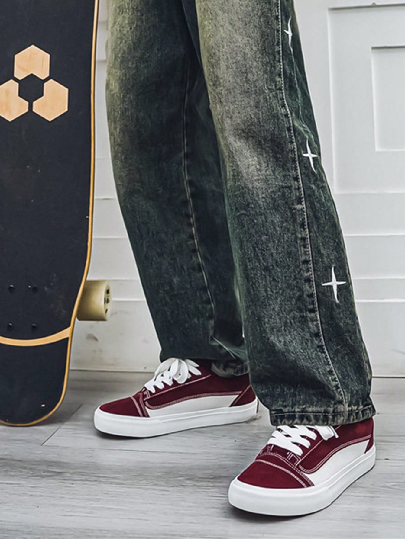 Burgundy and white low-top sneakers with lace-up closure, mesh upper, and flat rubber outsole, modern streetwear shoes