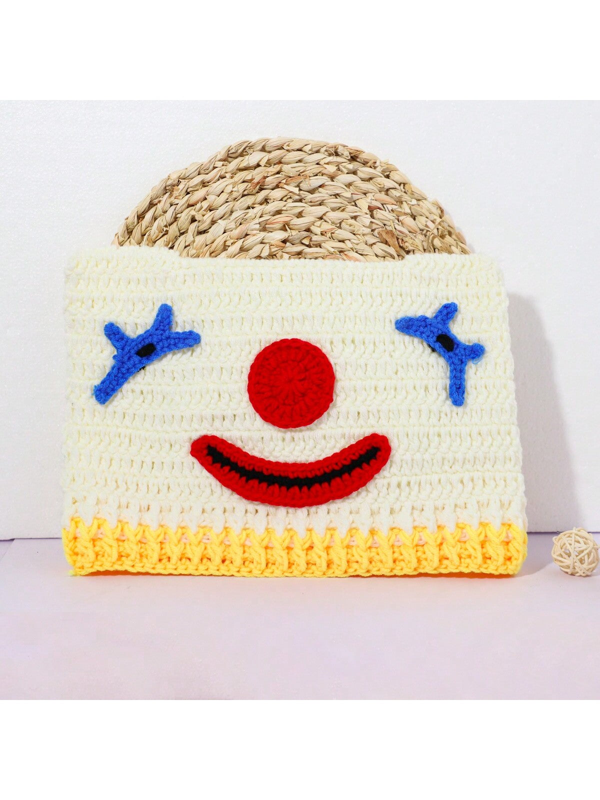 Hand-crocheted clown face beanie for women with red nose and blue stitched eyes, Halloween streetwear knit hat