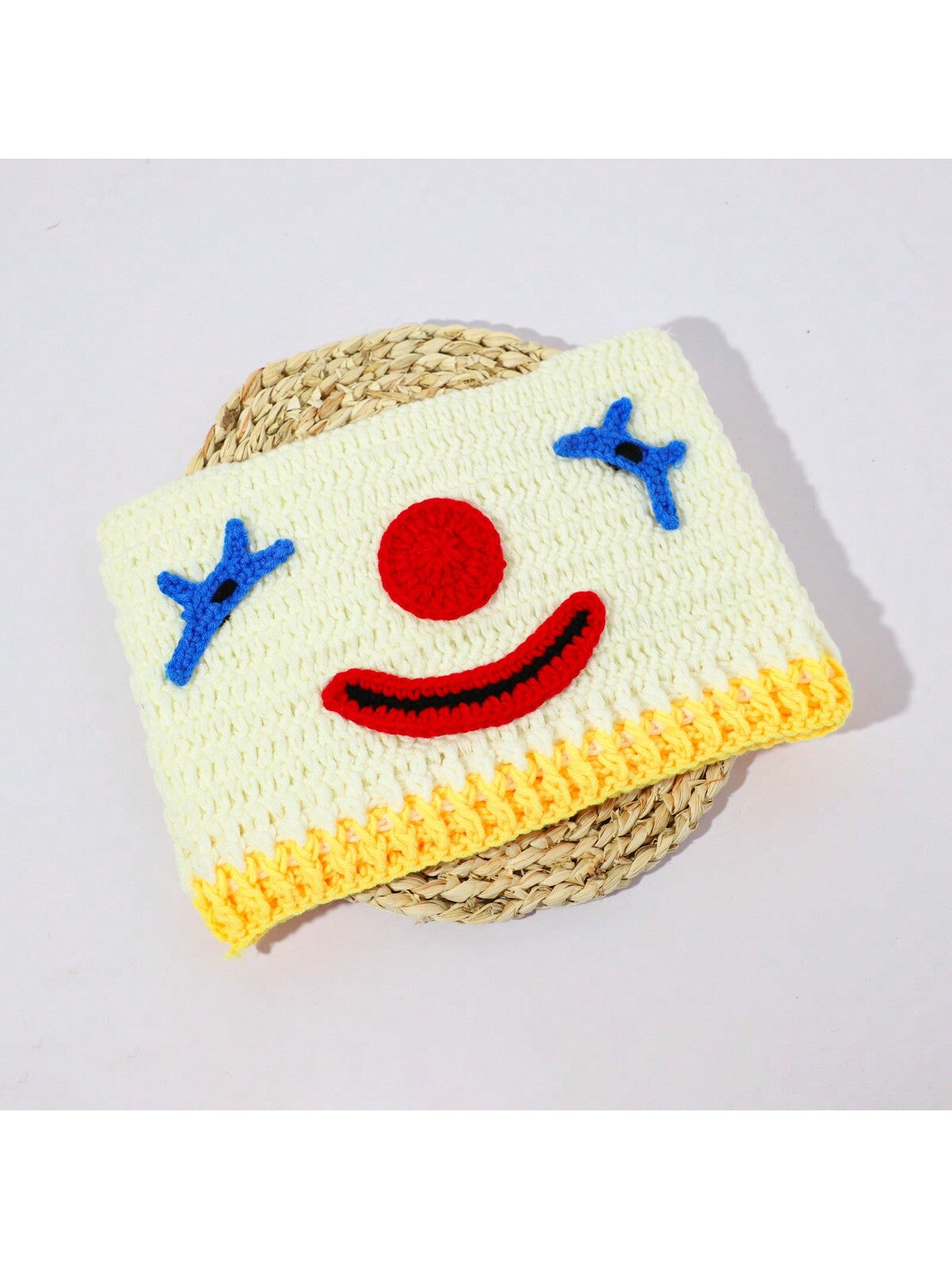 Hand-crocheted clown face beanie for women with red nose and blue stitched eyes, Halloween streetwear knit hat