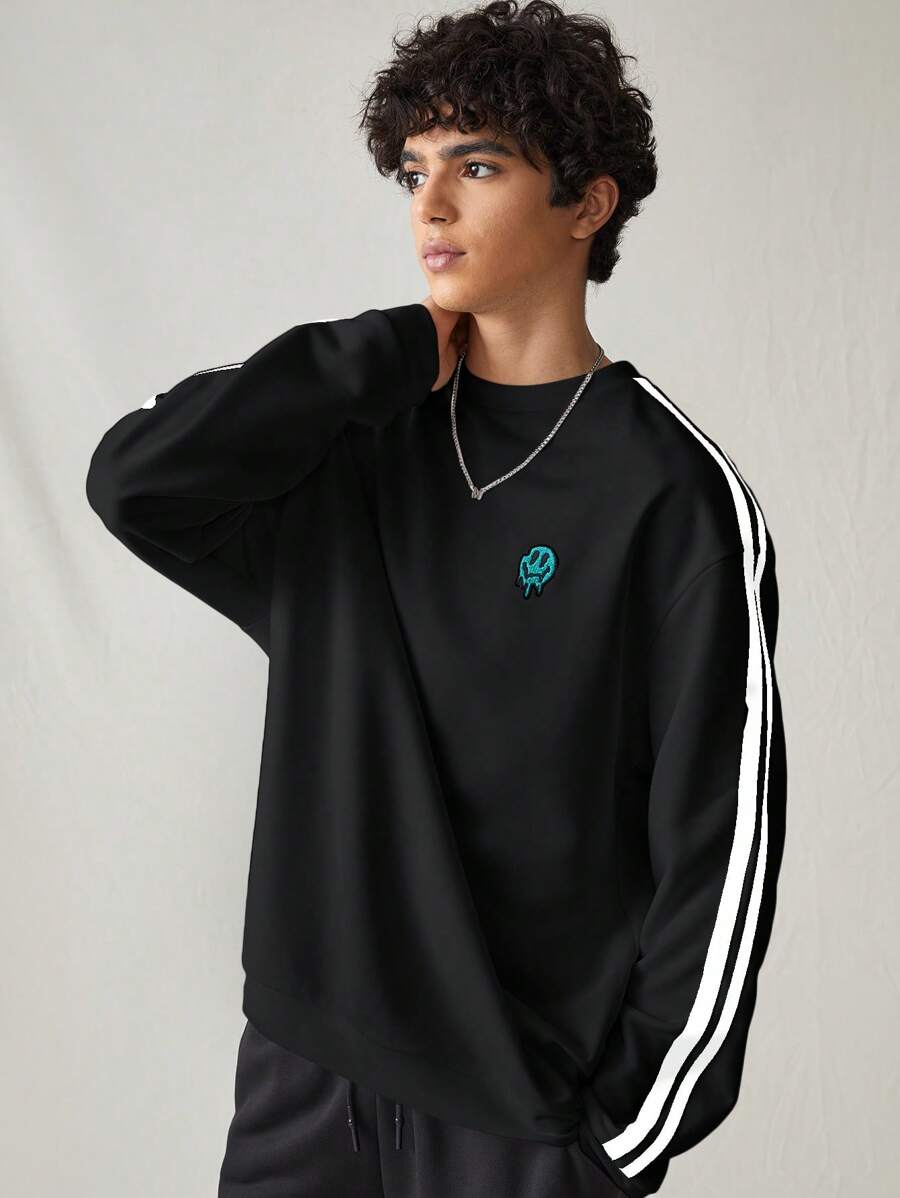 Japanese streetwear black pullover sweatshirt with white side stripes, loose fit, and embroidered chest detail