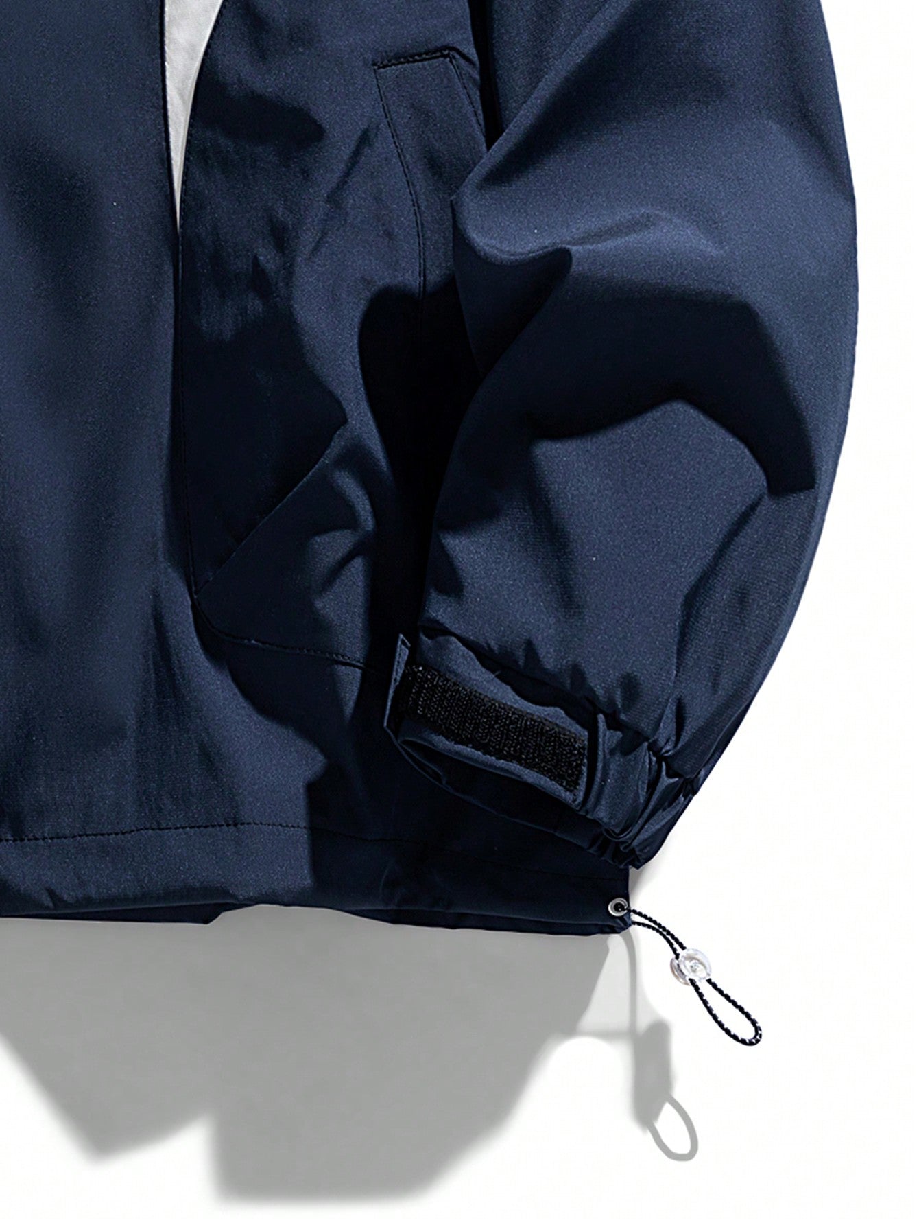 Japanese streetwear hooded windbreaker jacket in blue and white colorblock with zipper and drawstring