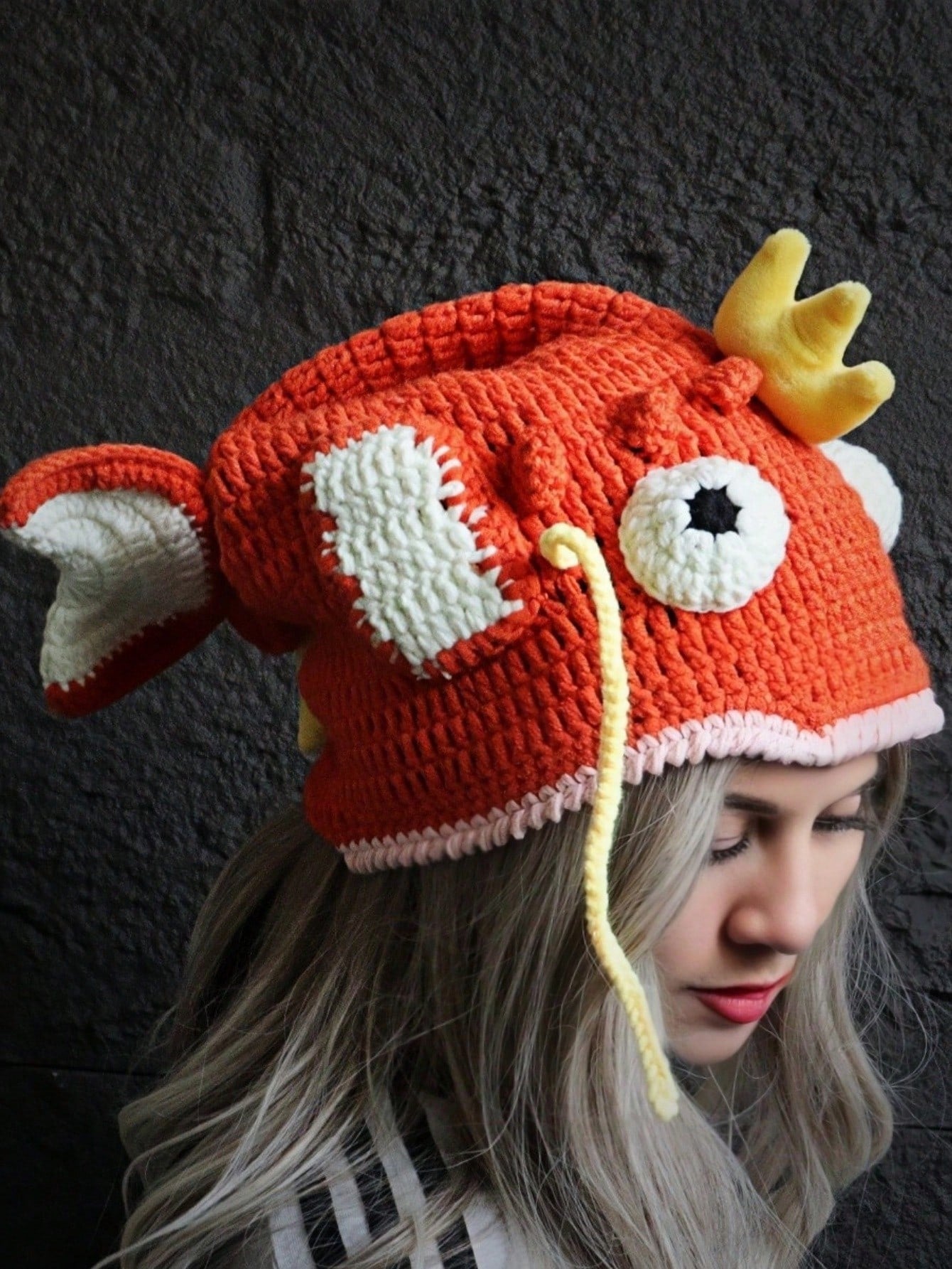 Orange crocheted fish hat with large fins, cartoon eyes, and crown, Magikarp-inspired kawaii streetwear beanie for women