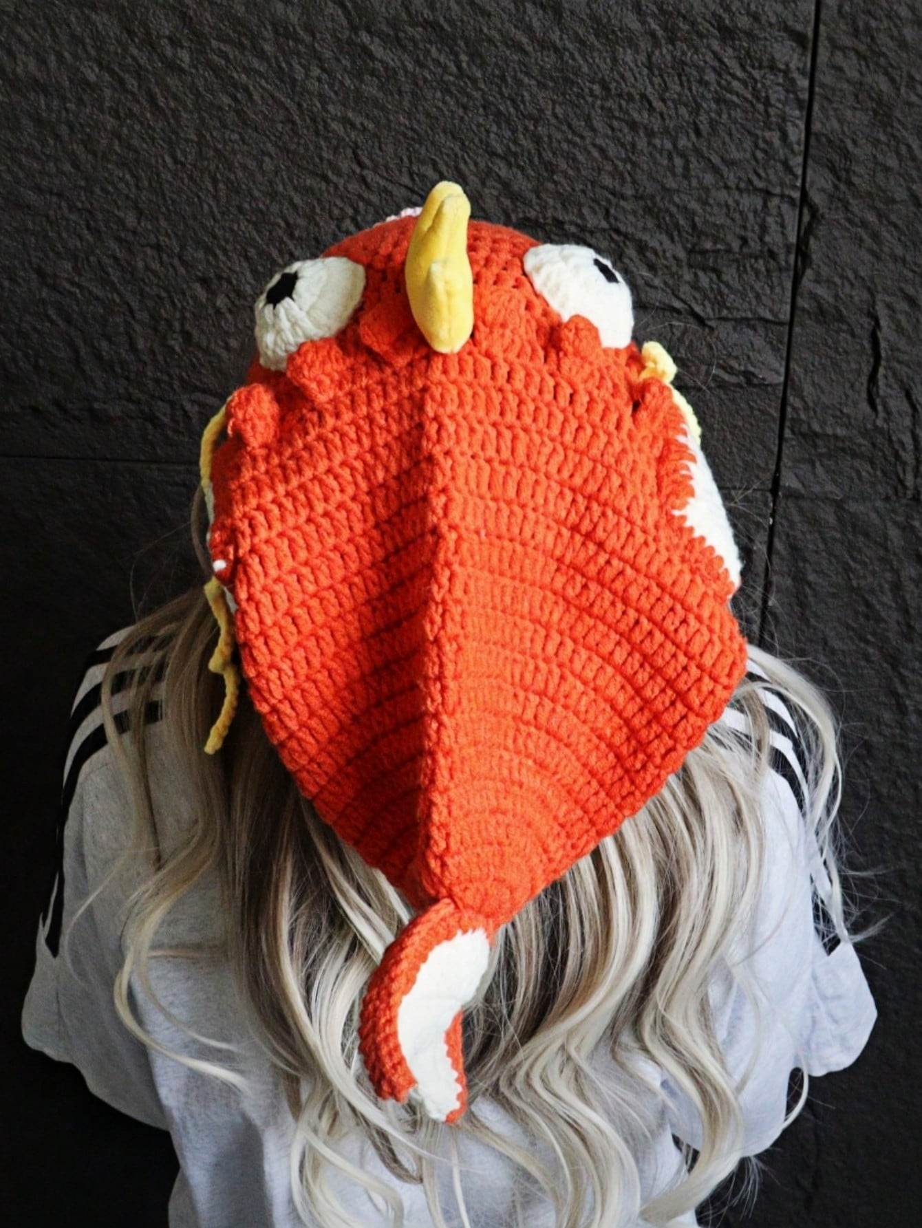 Orange crocheted fish hat with large fins, cartoon eyes, and crown, Magikarp-inspired kawaii streetwear beanie for women