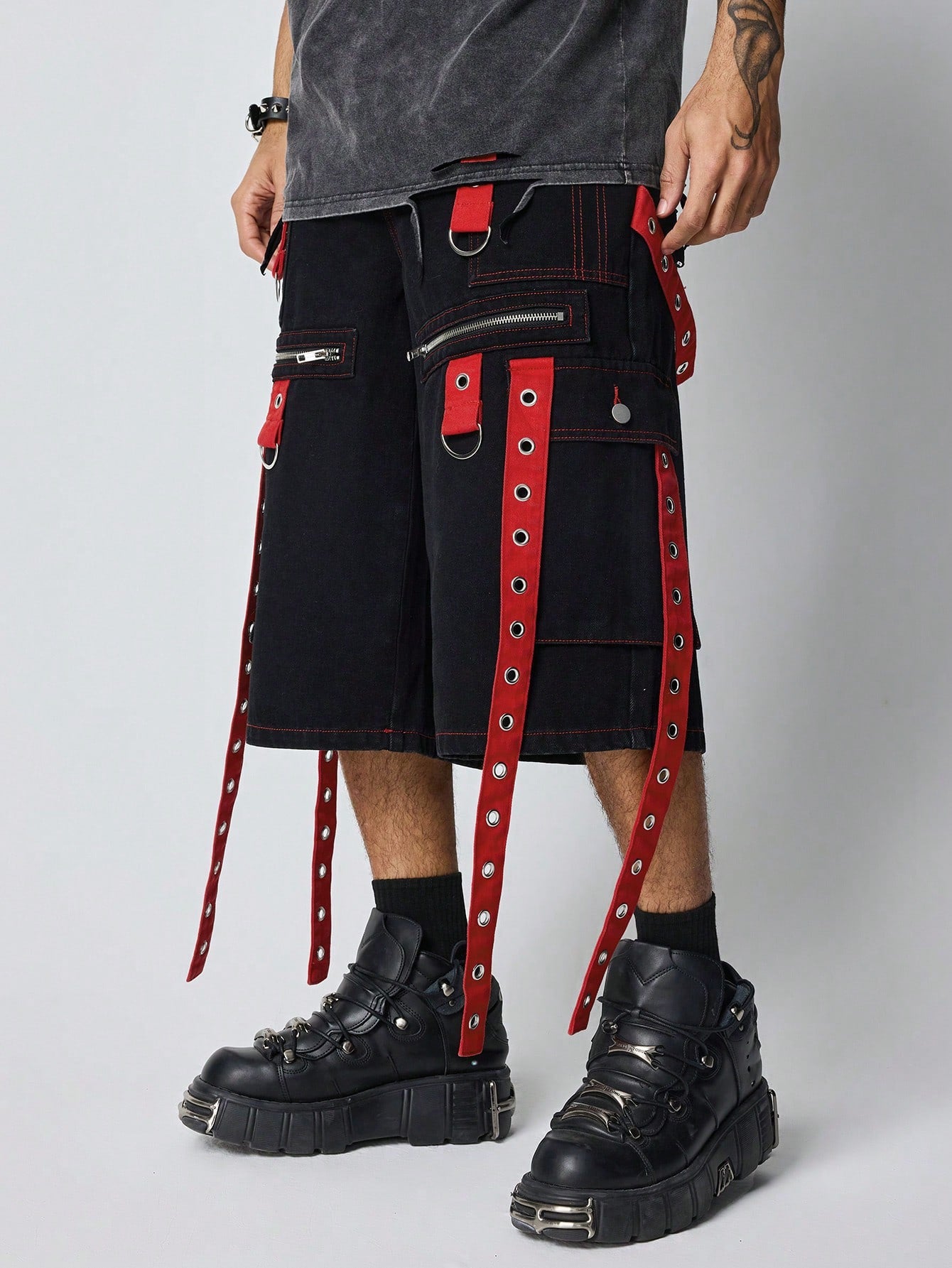 Black and red denim Bermuda shorts with straps, zippers, and pocket details – Japanese streetwear style