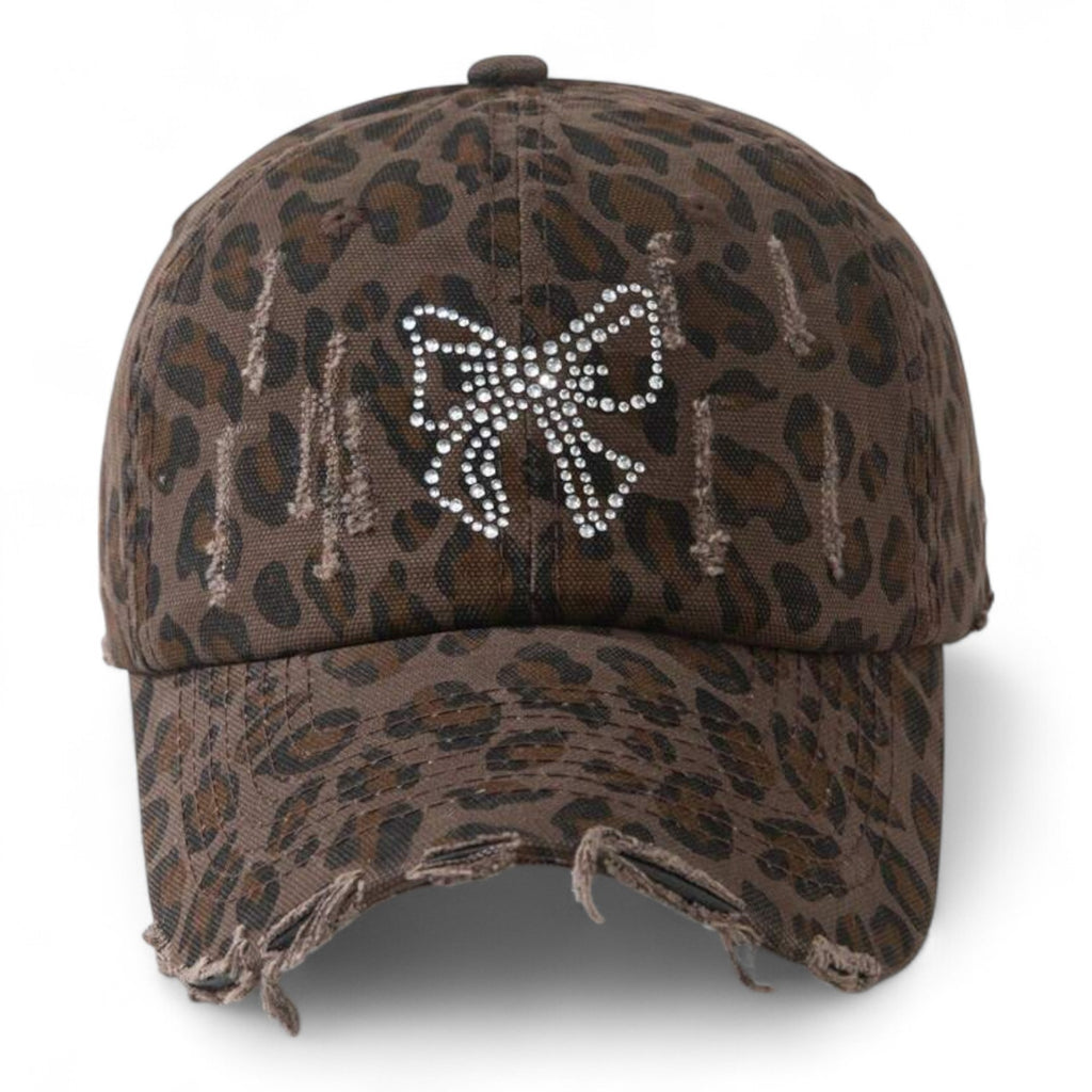 Leopard print baseball cap with rhinestone bow and distressed edges, unstructured dad hat for women, Y2K glam streetwear style

