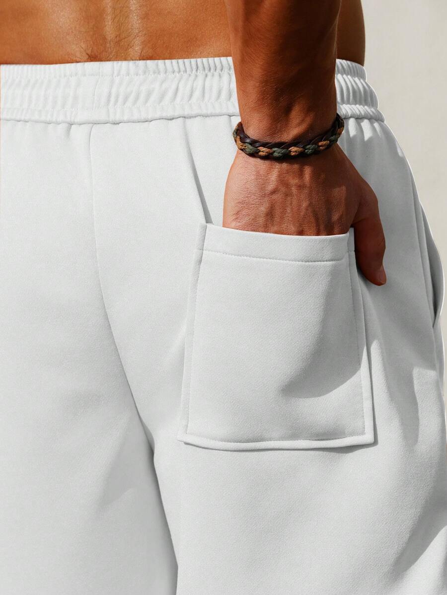 Men’s white and black colorblock drawstring shorts with patch pockets and letter detail