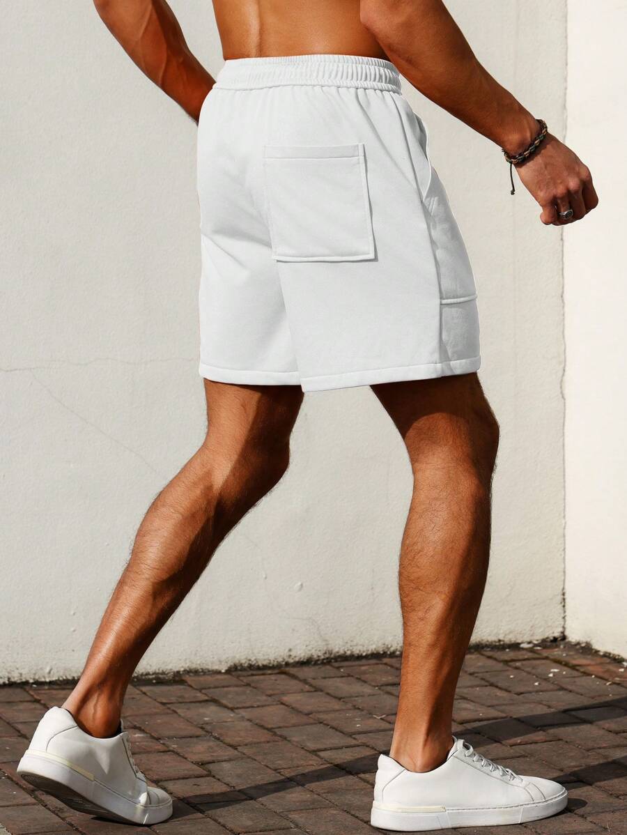 Men’s white and black colorblock drawstring shorts with patch pockets and letter detail